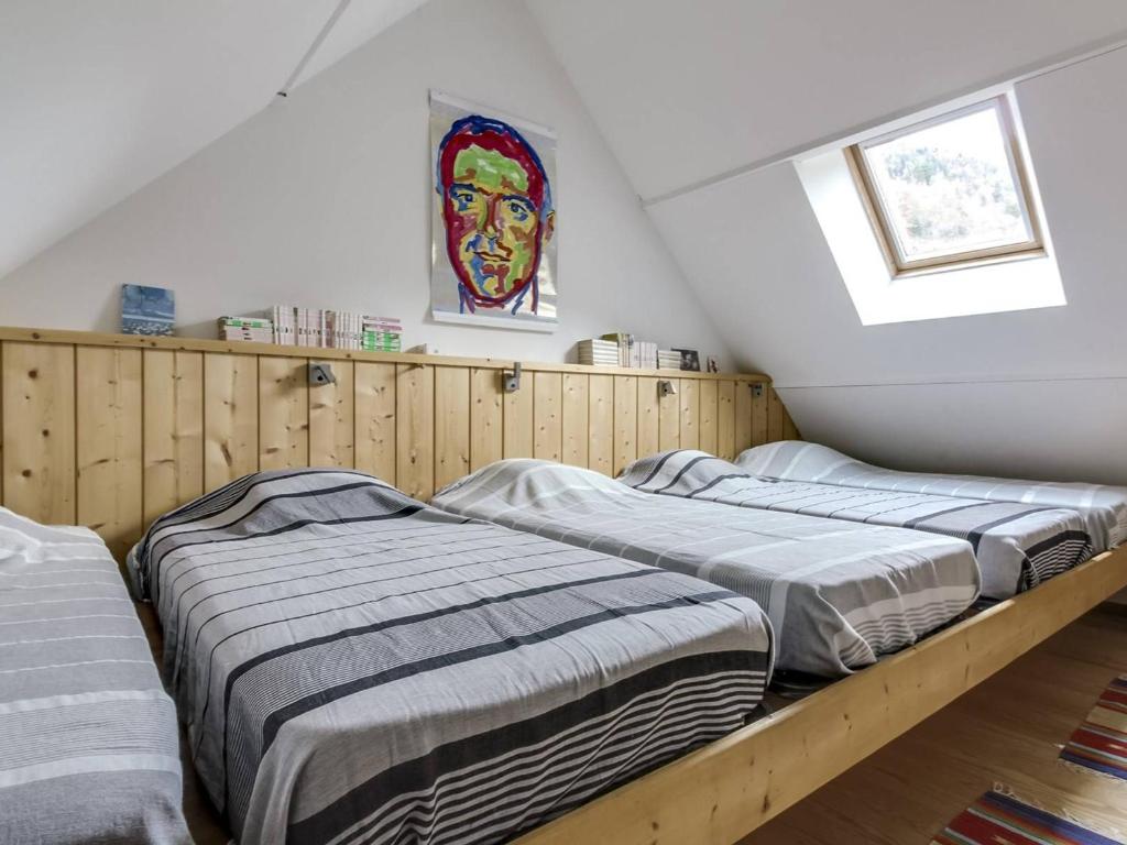 two beds in a room with a painting on the wall at Appartement Barèges, 4 pièces, 9 personnes - FR-1-403-64 in Barèges