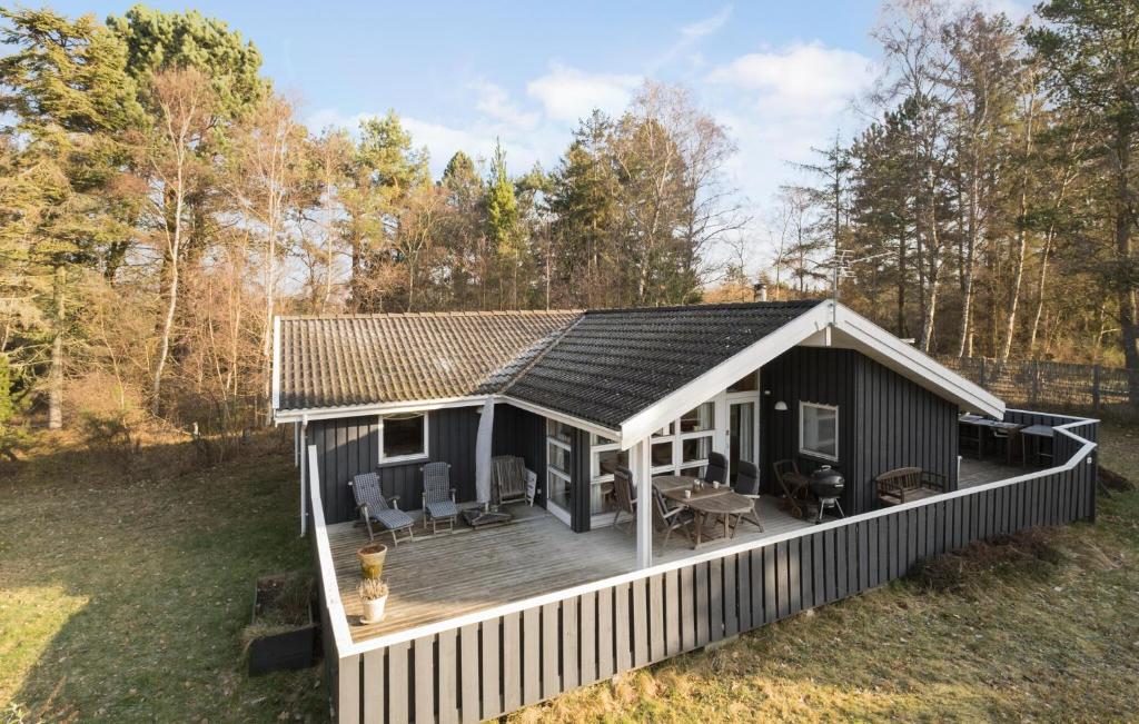 a small house with a deck in a field at Beautiful Home In Sjllands Odde With Wifi in Tjørneholm