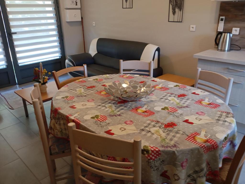 a dining room table with a christmas table cloth at Charmant Gîte Familial à Saint-Benoît-sur-Loire - 2 Chambres, Parking, Proche Patrimoine et Nature - FR-1-590-426 in Saint-Benoît-sur-Loire
