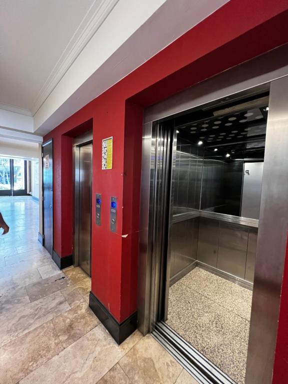 a row of elevators in a building with red walls at Apartamento premium Tower SL in San Luis