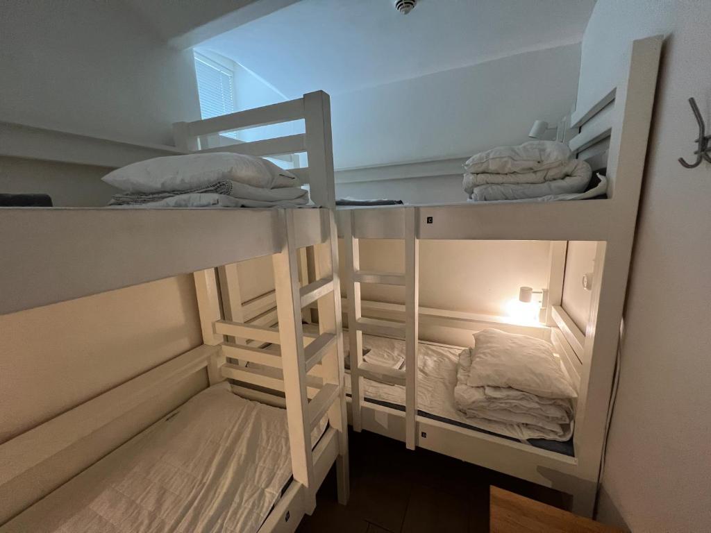 two bunk beds in a room with a ladder at Hostel Dalagatan in Stockholm