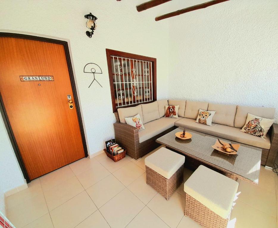 a living room with a couch and a table at 200 m playa, WiFi, TV SAT, BBQ in Pilar de la Horadada