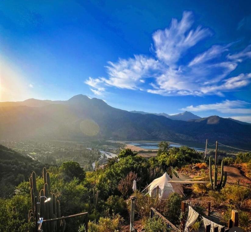 a view of a valley with cacti and mountains at @alasaguas in San José de Maipo