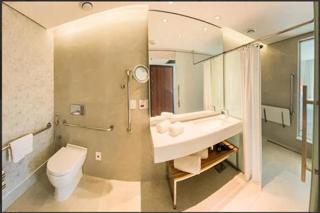 a bathroom with a sink and a toilet and a mirror at HOTEL NACIONAL BLOCO 01 1512/013 in Rio de Janeiro