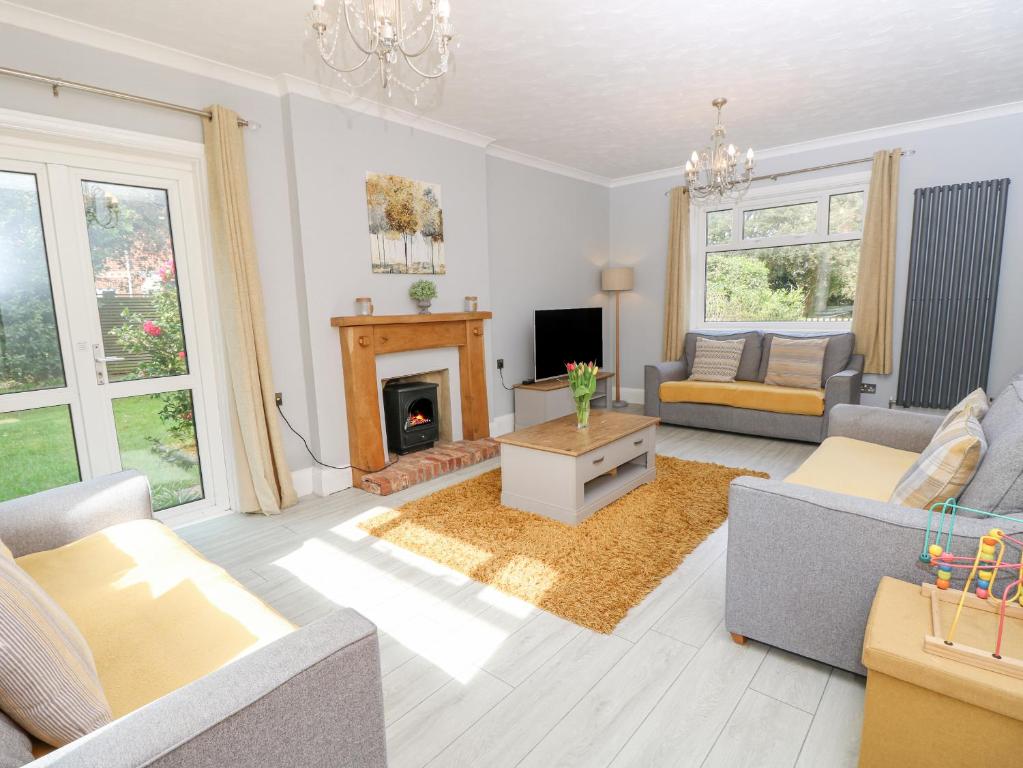 a living room with a couch and a fireplace at Morningside in Totland