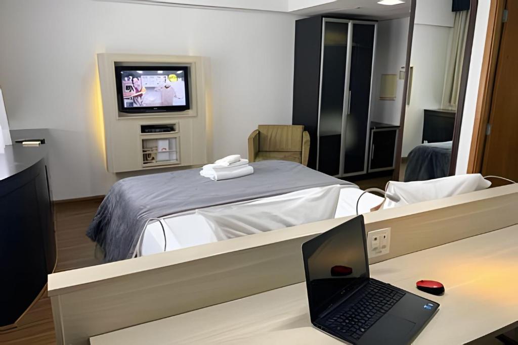 a hospital room with a bed and a laptop on a desk at Get a Flat 1203 Bela Vista Excelente Localização SP in Sao Paulo