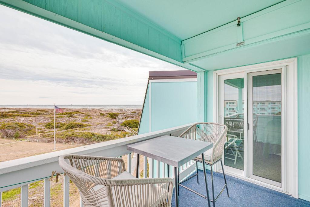 a table and chairs on a balcony with a view of the ocean at Chic Condo with Ocean Views and Pool - Walk to Beach! in Atlantic Beach
