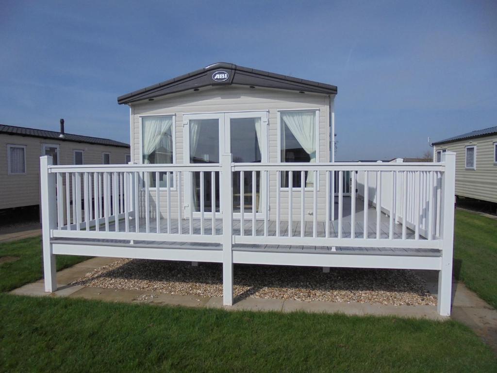 a white gazebo with a black roof at Kingfisher Windermere 6 Berth, Enclosed veranda, Close to site shop in Ingoldmells