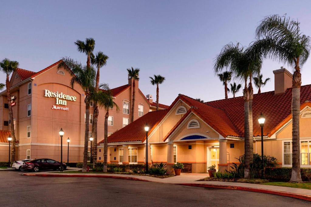 a hotel with palm trees in front of a building at Residence Inn Anaheim Hills Yorba Linda in Anaheim