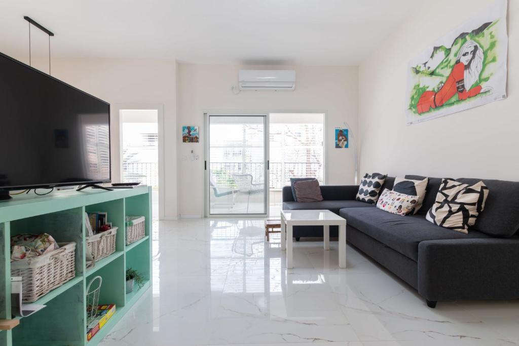 a living room with a couch and a table at Cozy 2BR Heart in Tel Aviv in Tel Aviv