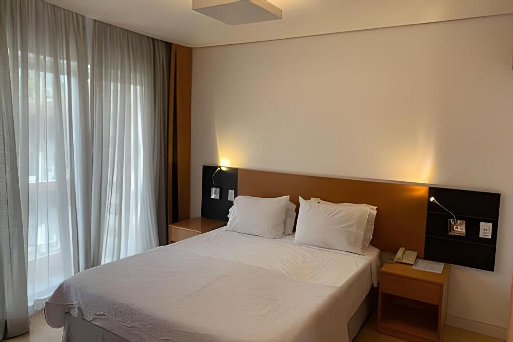 a bedroom with a large bed and a window at Get a Flat 701 - Ibirapuera -Jardins in Sao Paulo