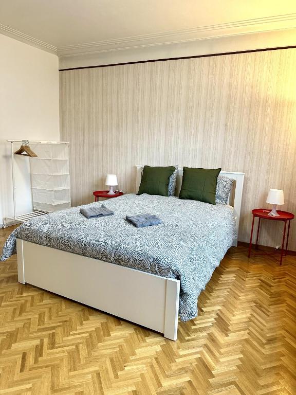a bedroom with a large bed and two tables at Maison entière/ Entire house with privat 3 Parking in Kayl