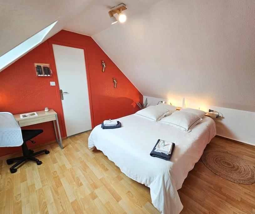 a bedroom with a large white bed and a desk at Ô P'tit Billard Baventais in Bavent