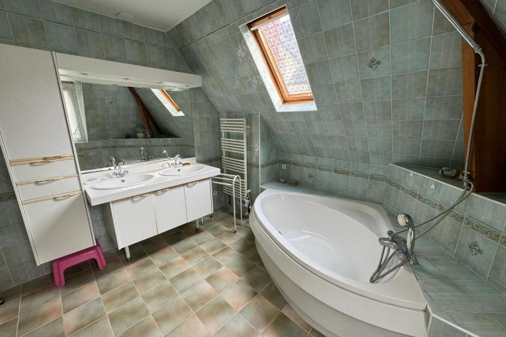 une salle de bain avec une baignoire et un lavabo et une baignoire dans l'établissement Norman house facing the sea, à Villerville