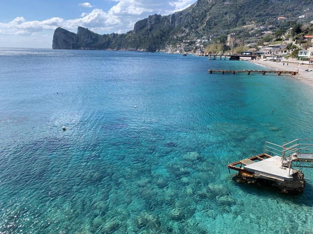 a boat in the water next to a beach at Camping Villaggio Nettuno in Nerano