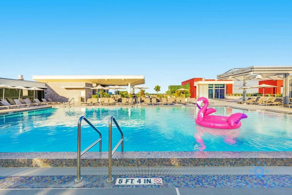 a swimming pool with a pink flamingo in the water at Amazing Pool - Gym - Hot Tub - Near Beach in Hollywood