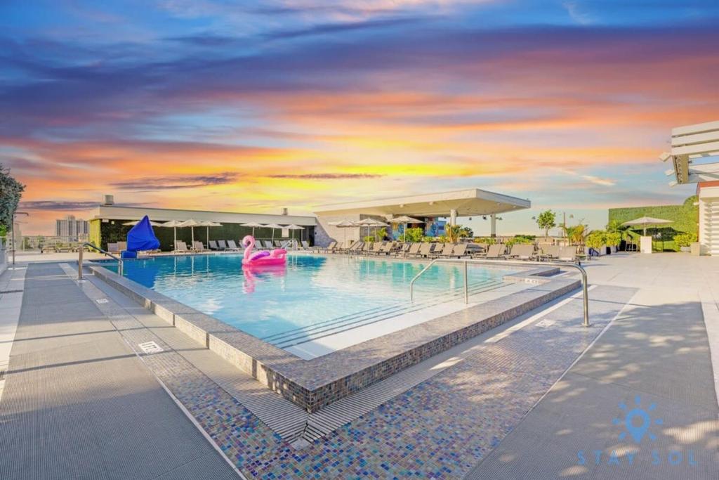 a pool at a resort with a person in the water at Amazing Pool - Gym - Hot Tub - Near Beach in Hollywood