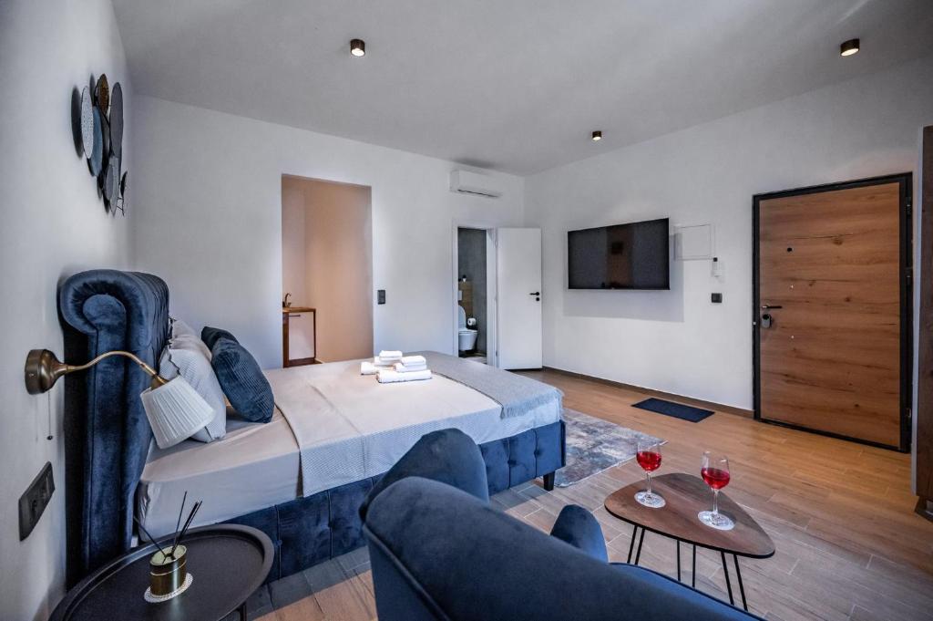 a bedroom with a bed and a couch and a tv at Apartments Portarata in Pula