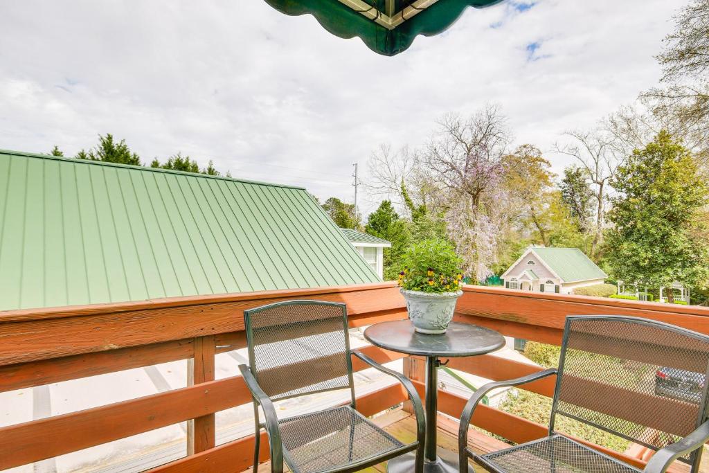 a patio with two chairs and a table on a balcony at Aiken Apt with Garden-View Balcony Half-Mi to Dtwn! in Aiken