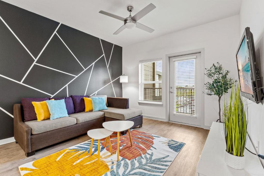 a living room with a couch and a table at Sleek Modern Gateway 10 Min to Parks Pets Allowed in Orlando