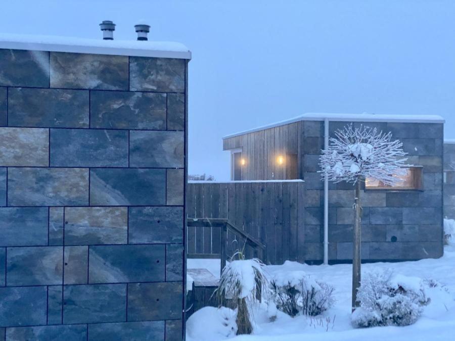 a building in the snow with a tree at roo'n in Arbesbach