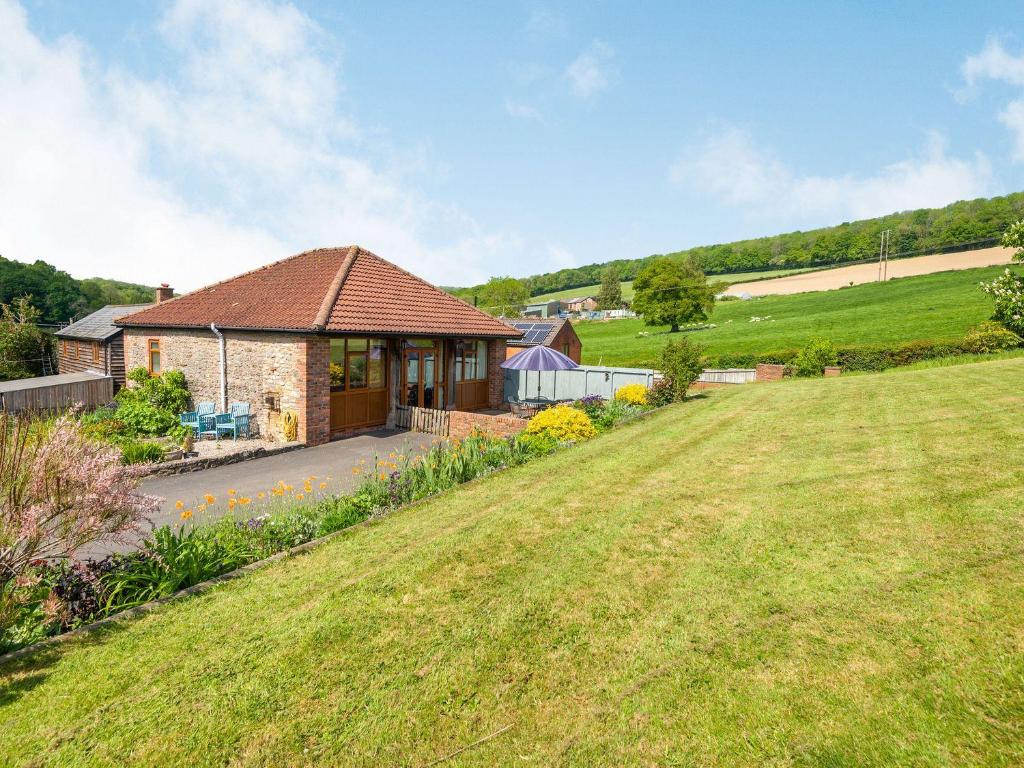 a house in a field with a grassy yard at The Carthouse in Hereford