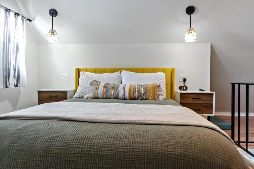 a bedroom with a large bed with two lights at Boho Modern Retreat with Mountain Views Unit 1 Durango in Durango