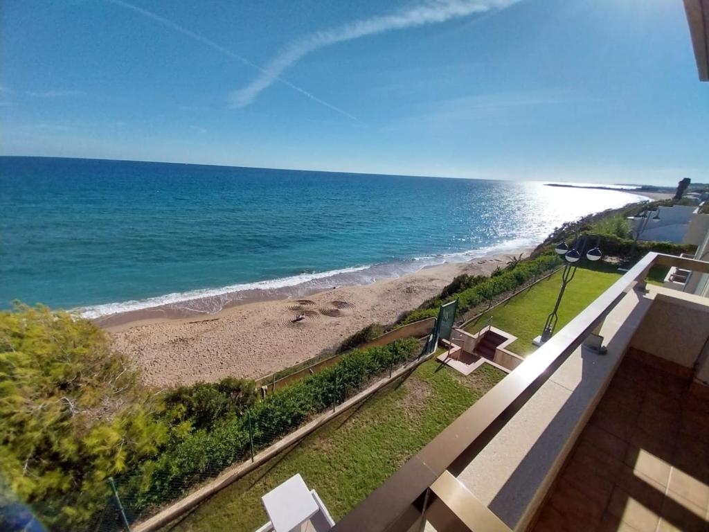 a view of the beach from the balcony of a condo at Playa Primera Linea Costa Dorada in Comarruga