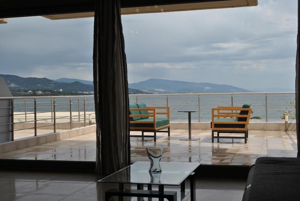 a living room with a view of the ocean at Blue Sea Horizon in Iraklitsa