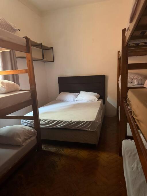 a bedroom with two bunk beds in a room at Julia Acomodações in Cabo Frio