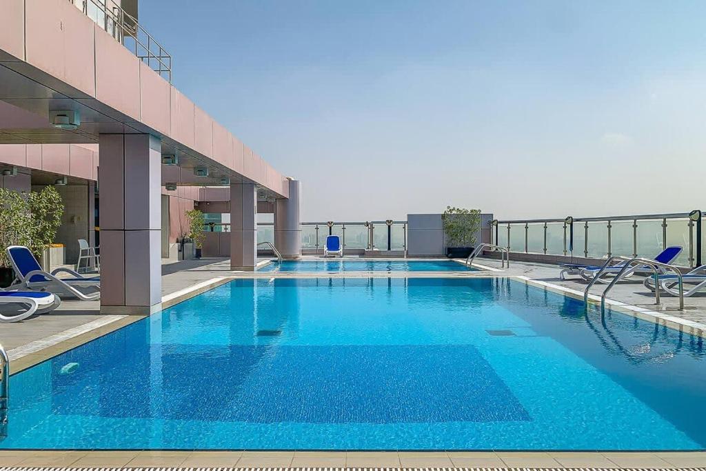 a large blue swimming pool on top of a building at Frank Porter - V3 Tower in Dubai