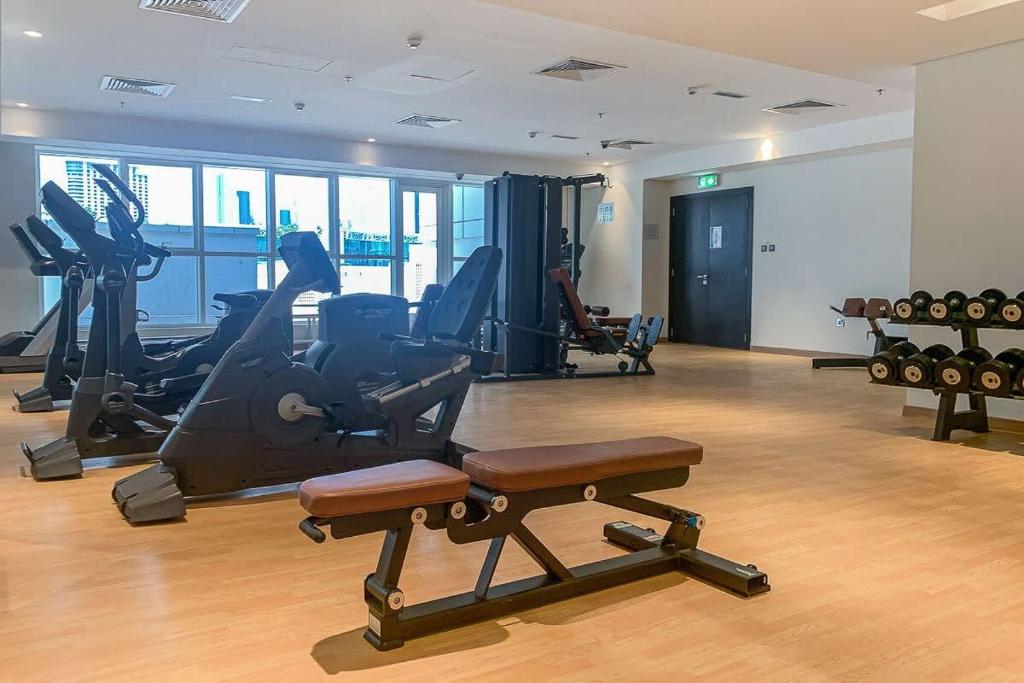 a gym with treadmills and exercise equipment in a building at Frank Porter - Mon Reve in Dubai