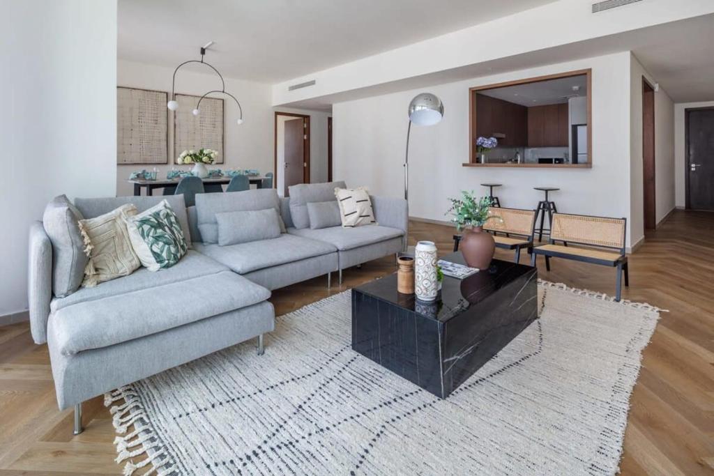 a living room with a couch and a table at Frank Porter - BLVD Heights T1 in Dubai