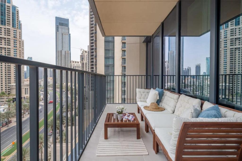 a balcony with a couch and a table at Frank Porter - BLVD Heights T1 in Dubai
