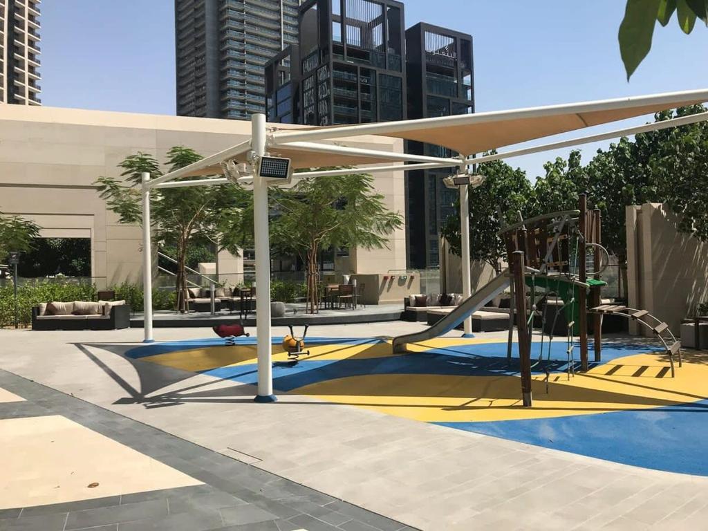 a playground with a slide and a play structure at Frank Porter - BLVD Heights T1 in Dubai