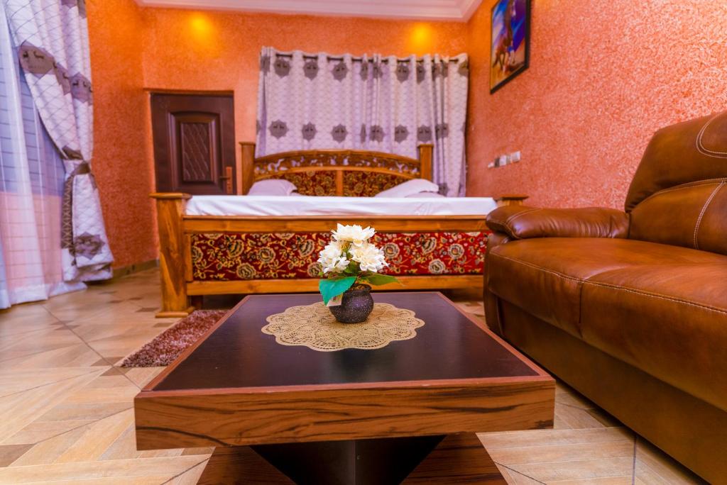 a living room with a couch and a table at Kobby Keach K. Hotel in Kumasi