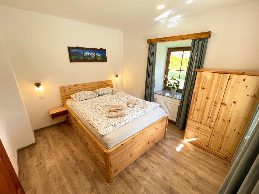 a bedroom with a bed and a window at Apartment House Prezlc in Kranjska Gora