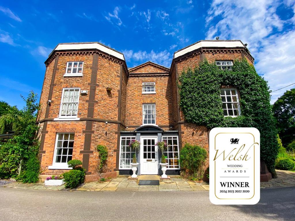 a brick building with a sign in front of it at Rossett Hall Hotel in Rossett