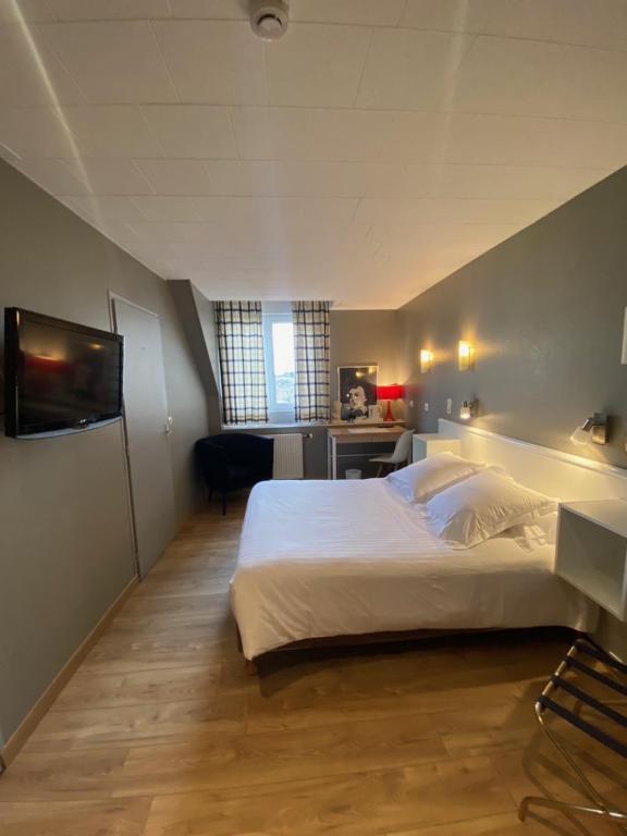 Postel nebo postele na pokoji v ubytování Hotel Le Pelican