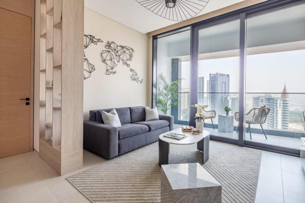 a living room with a couch and a table at Frank Porter - The Address JBR in Dubai