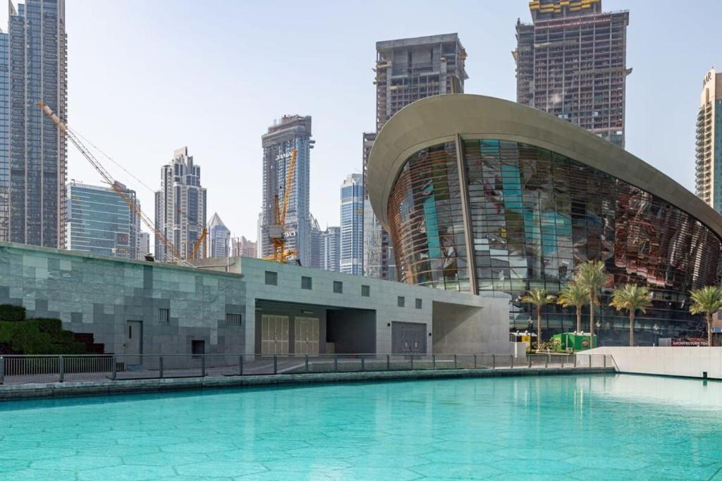 a swimming pool in a city with tall buildings at Frank Porter - The Lofts in Dubai