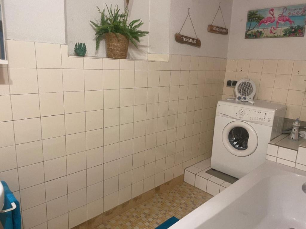 a bathroom with a washing machine in a sink at Ute Urbaner in Irschen