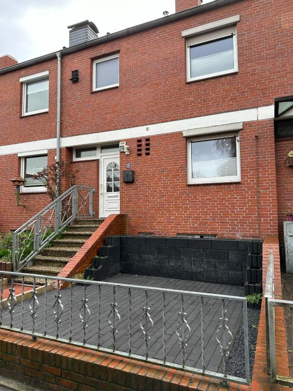 a brick building with a staircase in front of it at Ferienhaus Morgenstern in Wilhelmshaven
