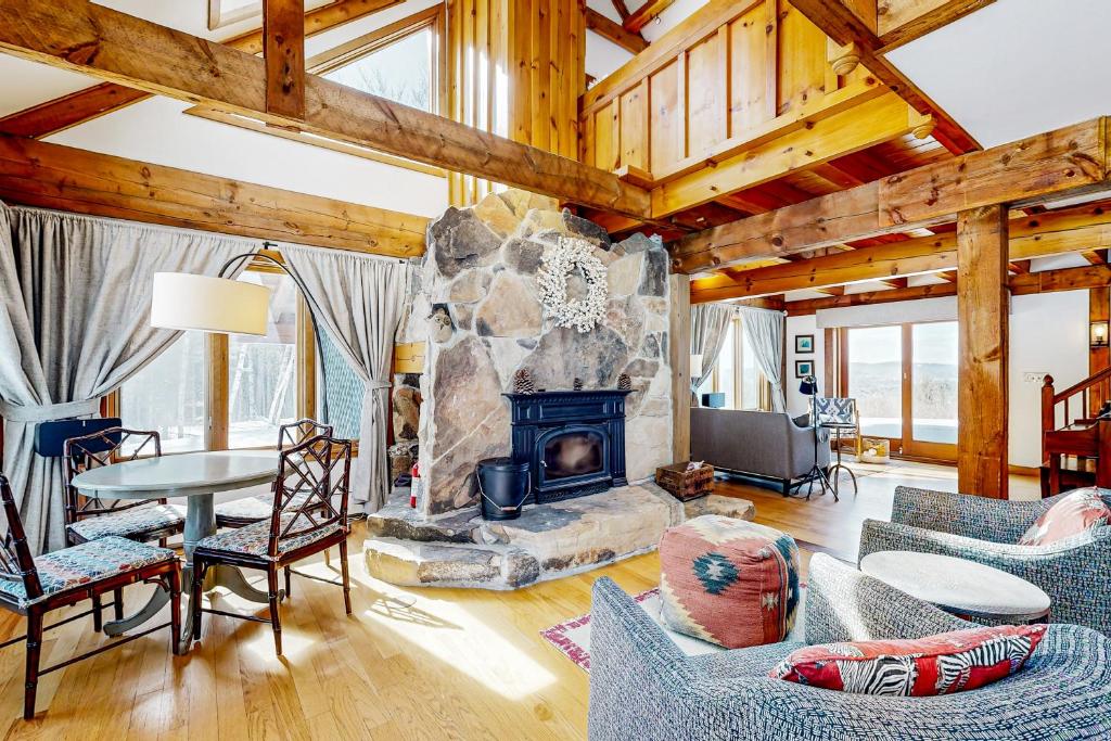 a living room with a stone fireplace at The Glengreen Retreat in Littleton