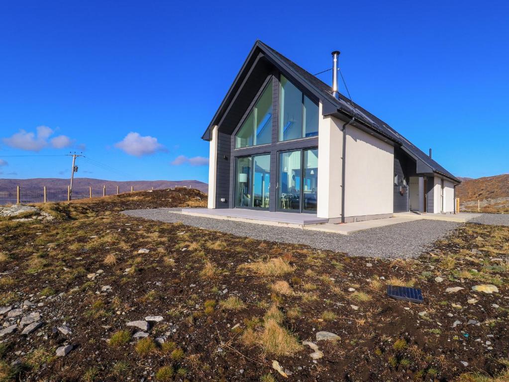 a house on a hill with a large window at 8B Carrigreich in Tarbert