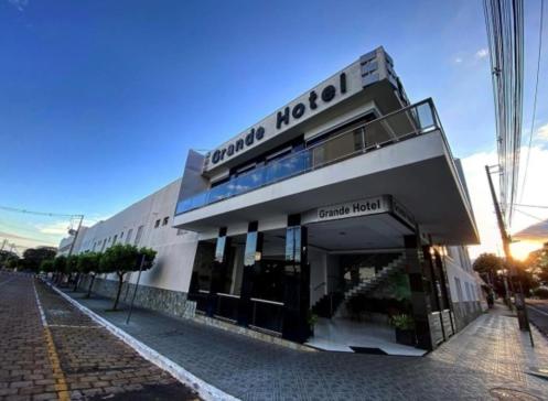 a building on a city street with a building at Grande Hotel in Paranavaí