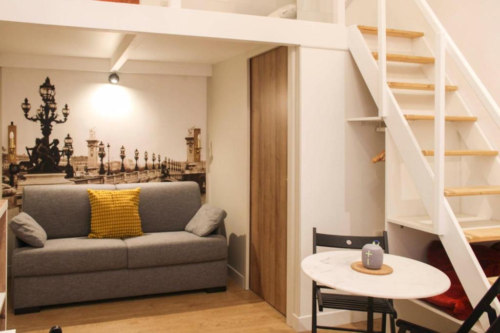 a living room with a couch and a table at Cosy love nest near Gare de l'Est in Paris