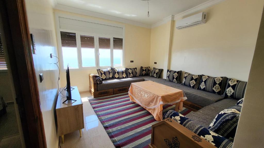 a living room with a couch and a table at Appartement centre de Taghazout 2 -WiFi in Taghazout
