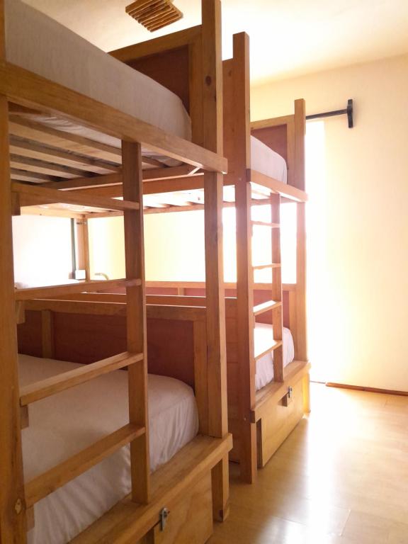 a bunk bed room with two bunk beds at Xtabentun Hostal in Cancún