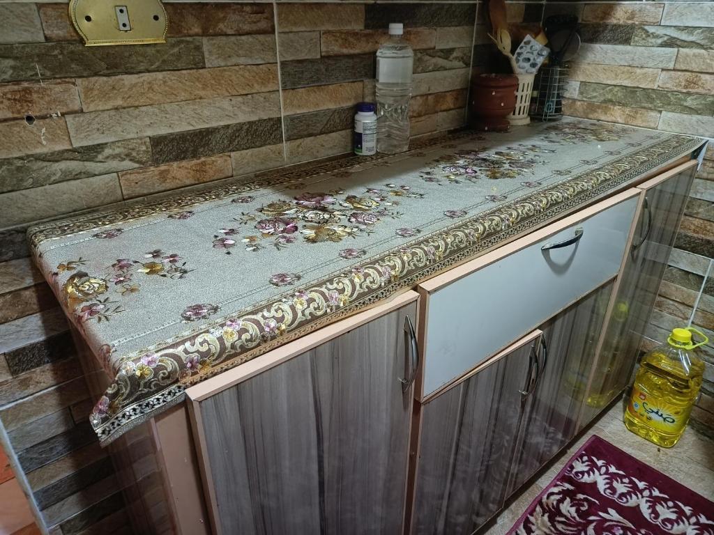 a kitchen counter with a counter top with a counter top at شقه فندقيه in ‘Ezbet el-Insha